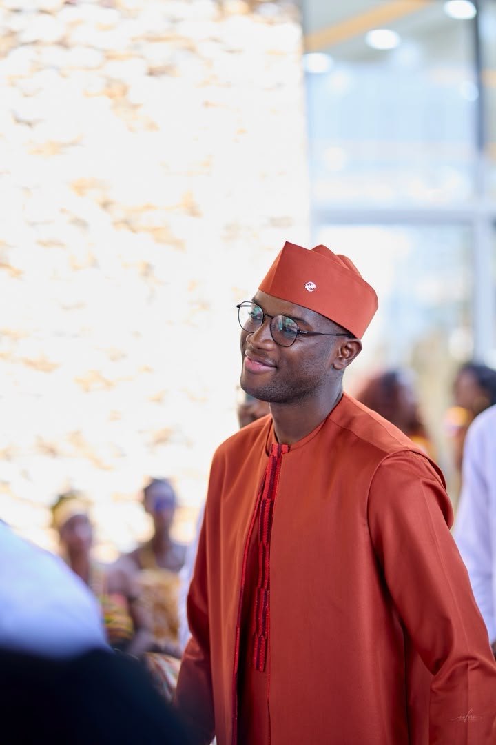 Richard in a coral agbada and cap