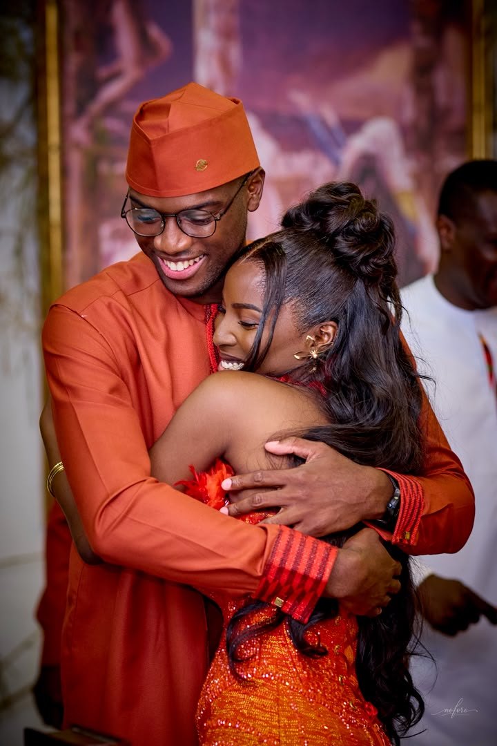 Asomdwe and Richard holding each other and laughing